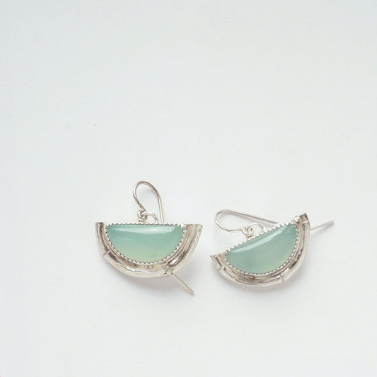 Earrings featuring half moon shaped semi precious aqua blue chalcedony gemstones, cupped by solid silver bamboo hammock, with simple wire ear hooks.