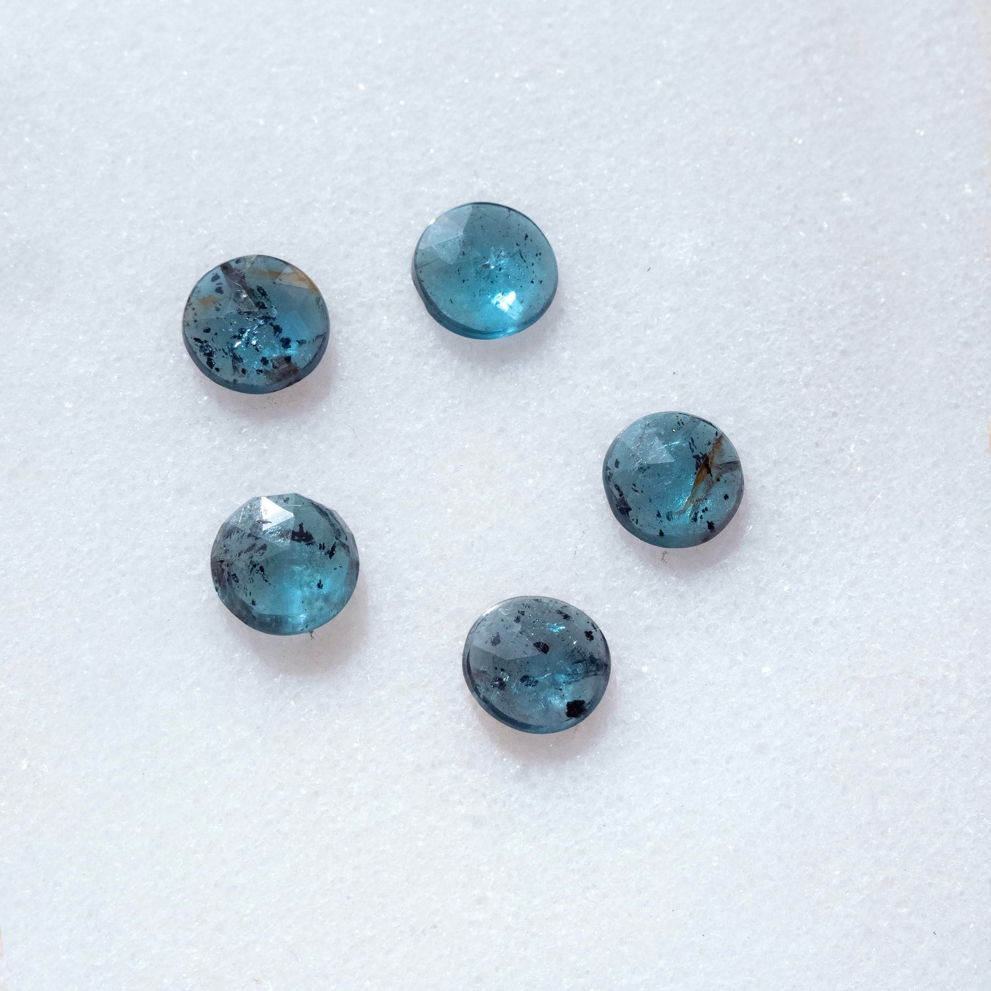 group of five speckled faceted teal blue Kyanite cabochon gemstones