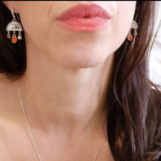 sterling silver half moon earrings, set with mother of pearl, engraved with squirrel illustration, and gemstone drops. Photographed on model.