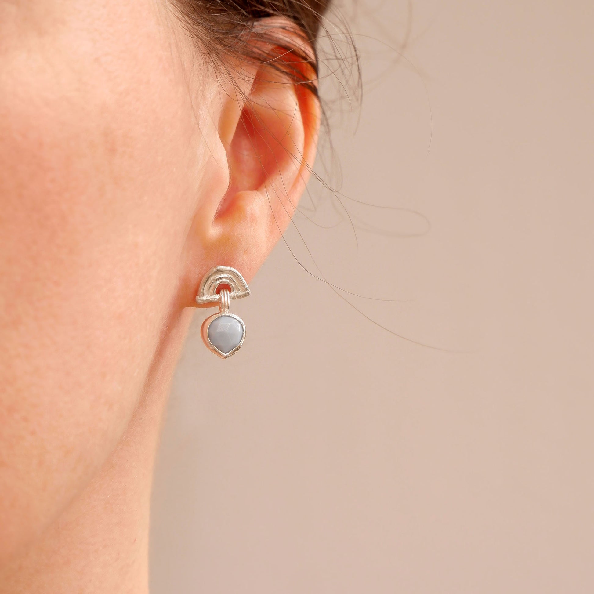 small stud earrings in Sterling Silver, featuring triple arches of bamboo, hung with a faceted blue opal gemstone pendant.