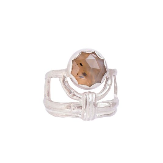 structural open-work ring in a bamboo style, featuring a faceted round  golden brown Montana Agate gemstone in a scalloped setting. Sterling Silver. white background