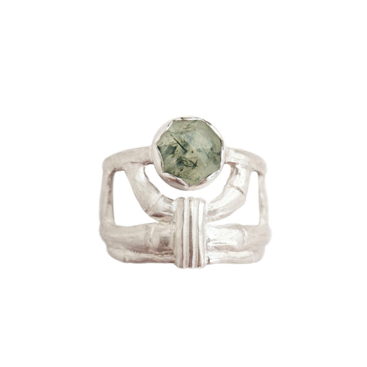structural open-work ring in a bamboo style, featuring a faceted round green rutilated Prehnite gemstone in a scalloped setting. Sterling Silver. white background