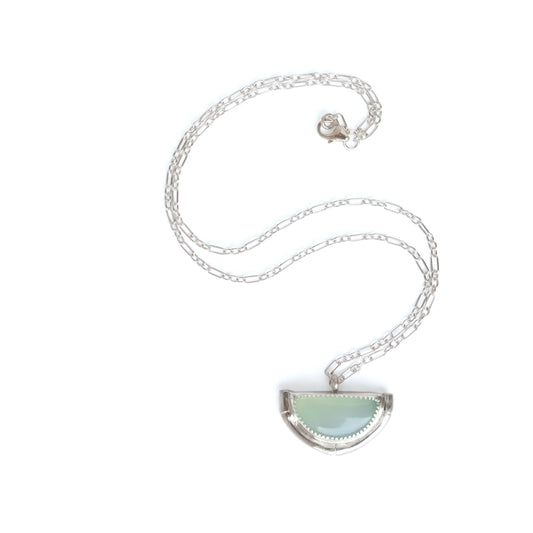 Half Moon pendant in aqua blue Chalcedony Gemstone, framed by a half mount of silver bamboo, on fine Silver figaro chain.