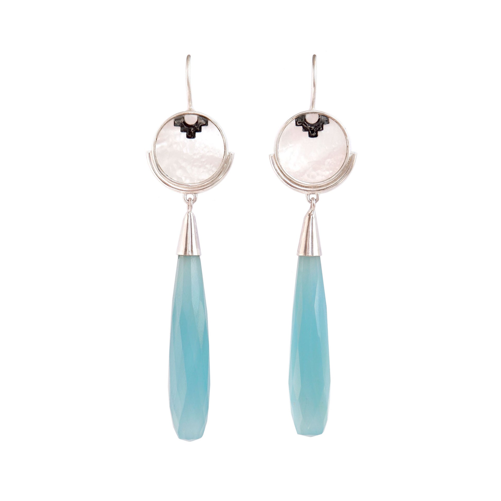 sterling silver earrings featuring mother of pearl discs, engraved with a blackened geometric steps design, and adorned with long blue faceted chalcedony gemstone drop pendants.
