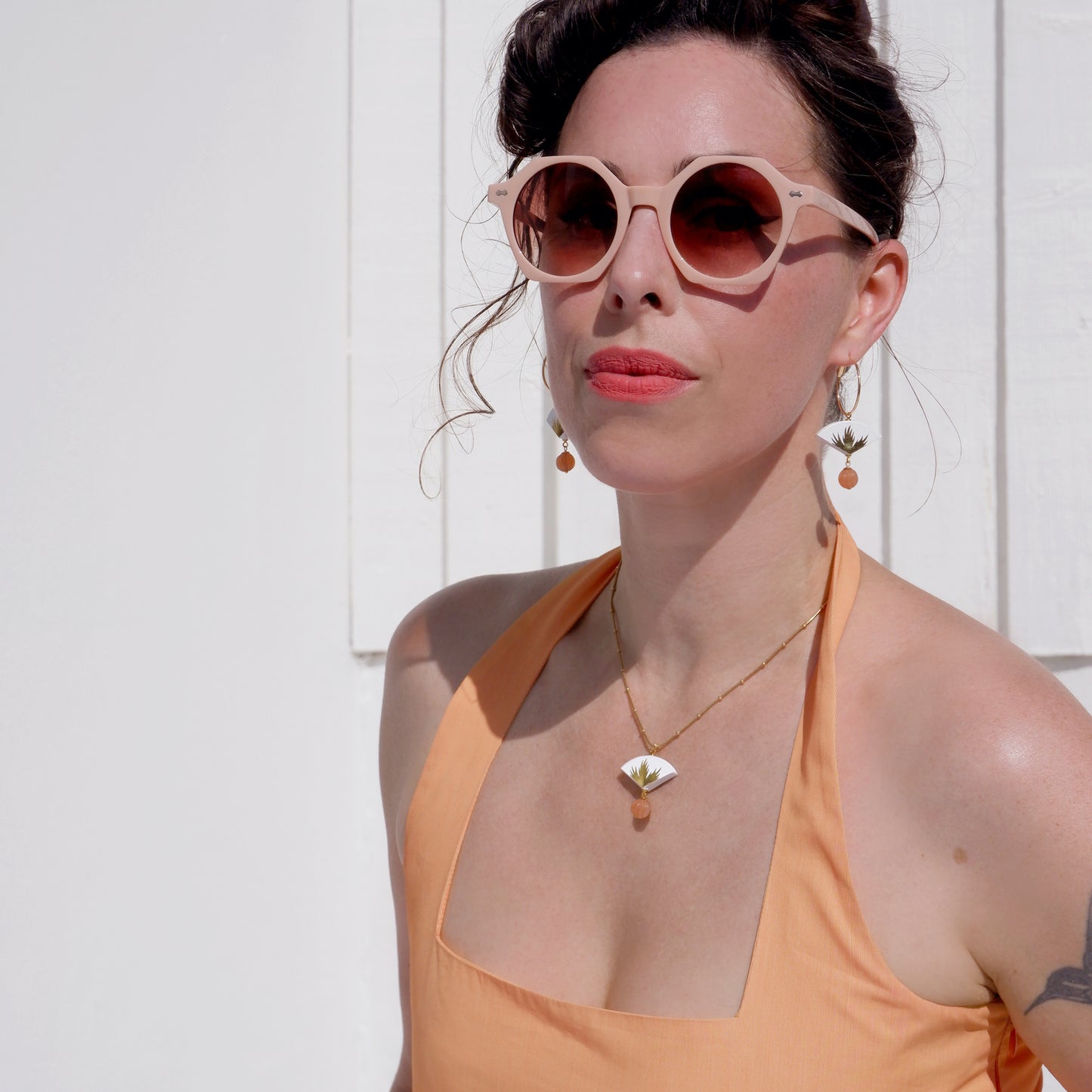small leather fan earrings & pendant, with gold palm leaf print, and dangling beads, on model