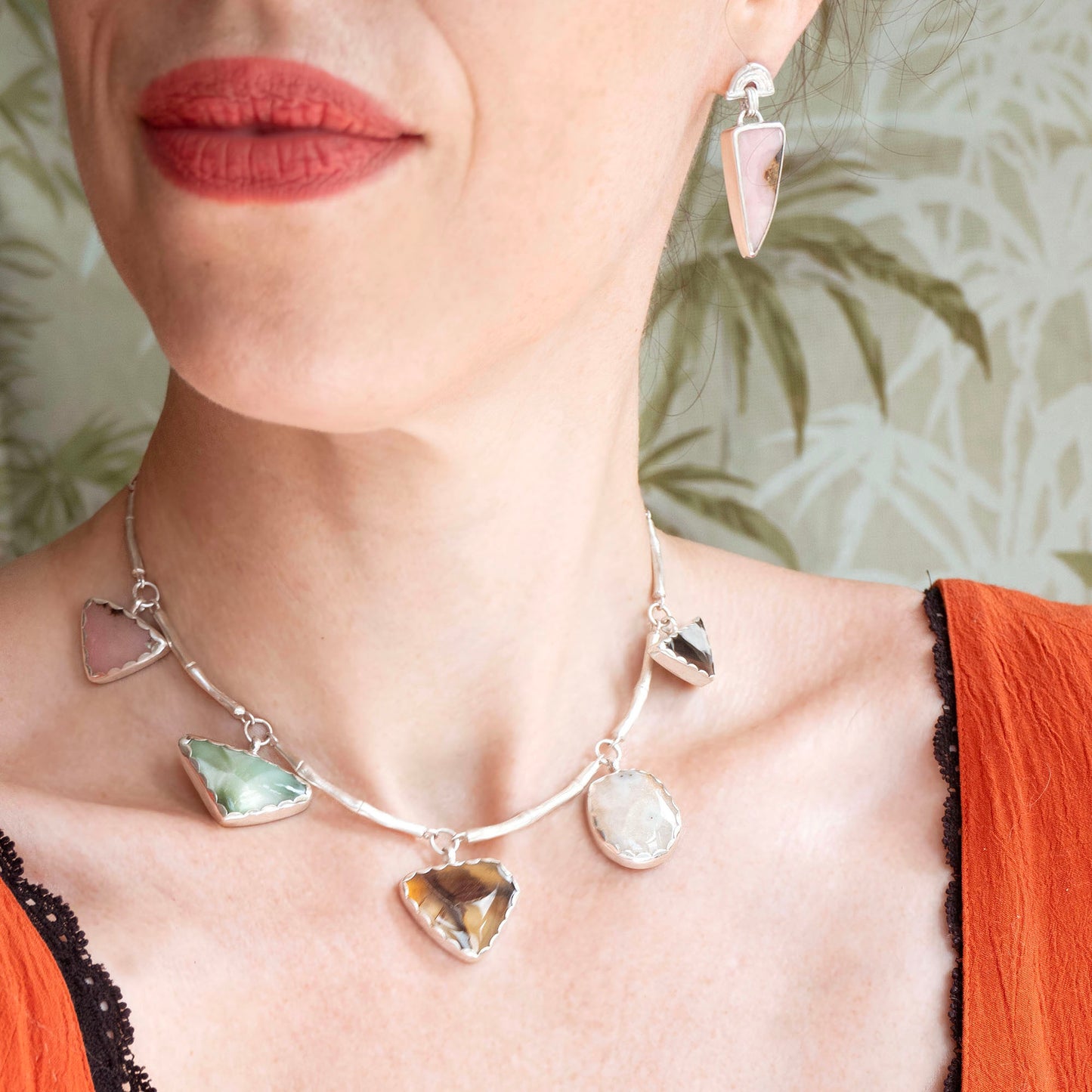 stud earrings in sterling silver, featuring triple arches of bamboo, hung with long pastel pink opal gemstone charm pendants. Shown on model for scale, with bamboo gemstone charm necklace.