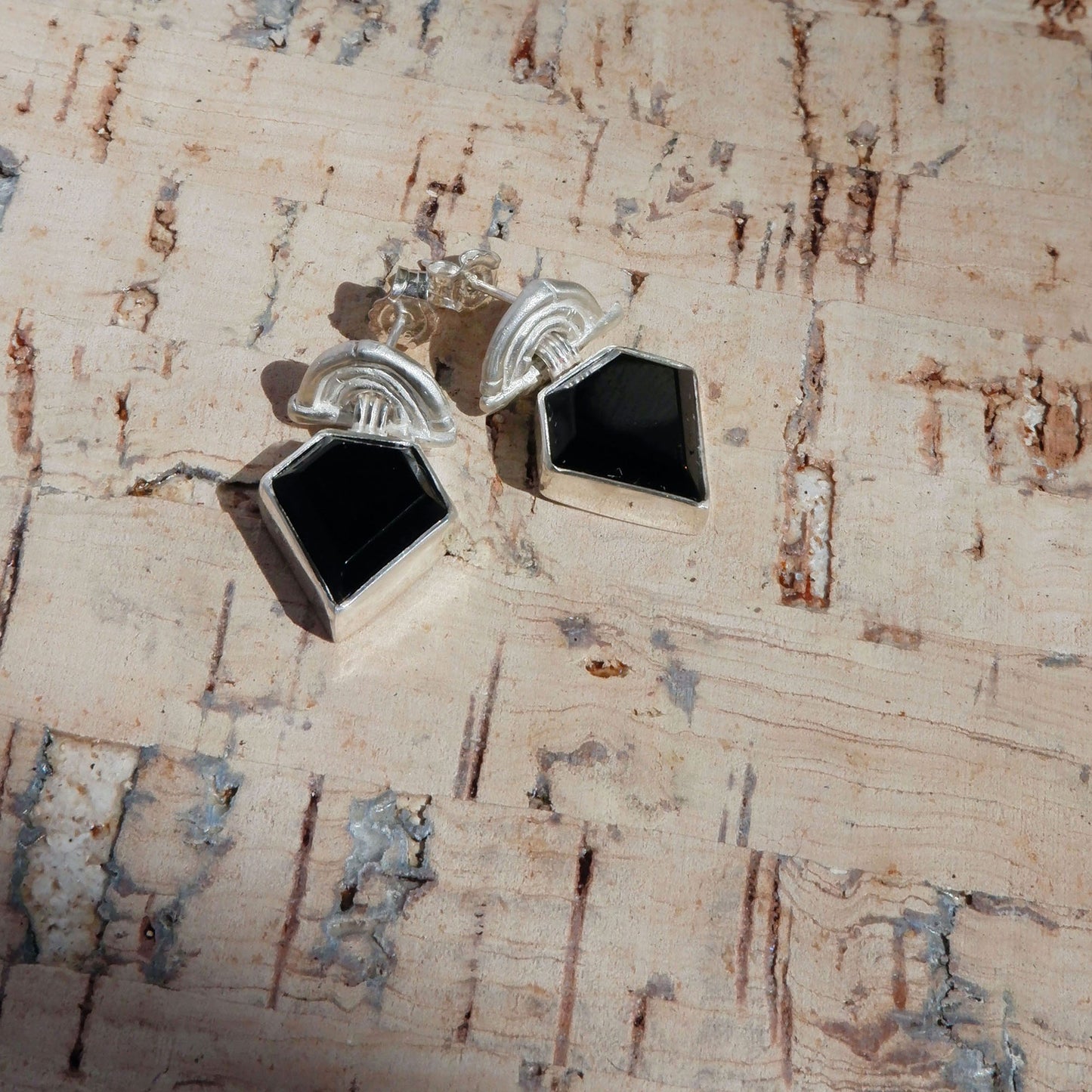 small stud earrings in sterling silver, featuring triple arches of bamboo, hung with diamond shaped Black Onyx gemstones