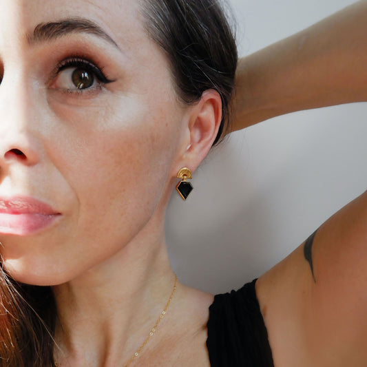 small stud earrings in gold vermeil, featuring triple arches of bamboo, hung with diamond shaped Black Onyx gemstones, shown on model