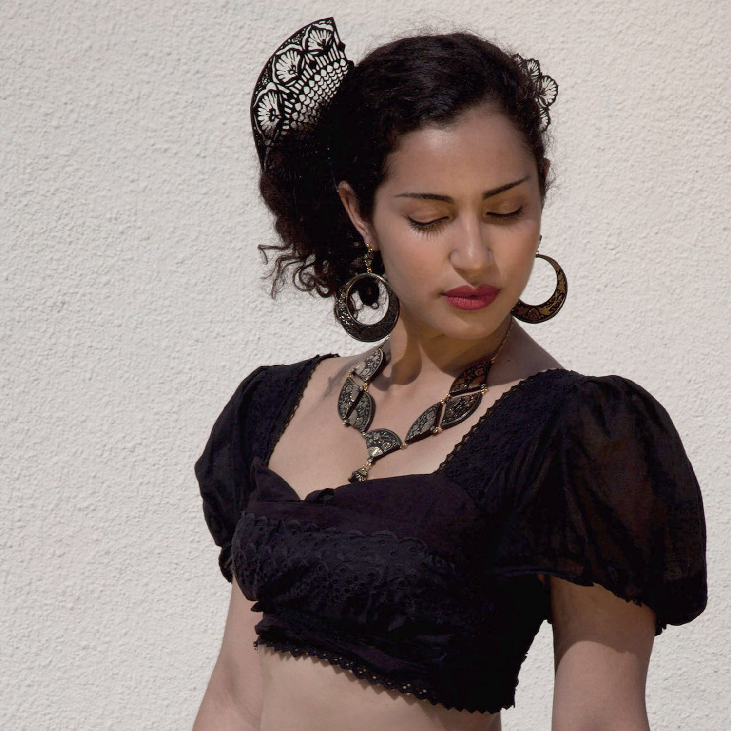 model wearing black laser-cut lace style leather hair combs & black leather jewellery