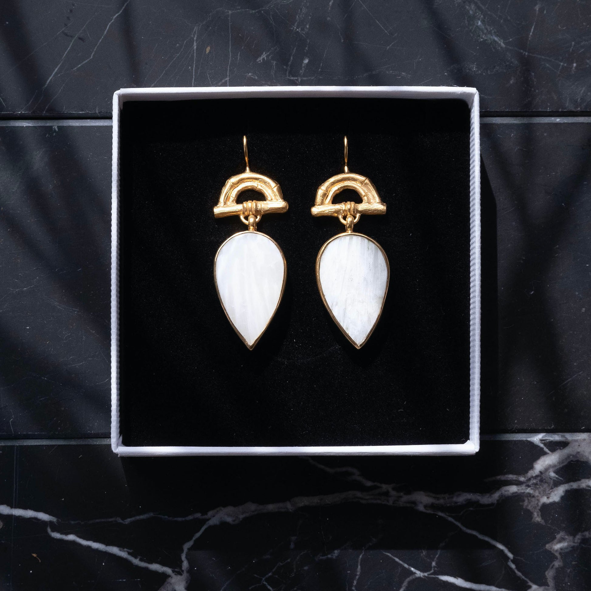Gold Vermeil hook earrings featuring bamboo sunrise arch design, with pointed gemstone drop pendants in white scolecite, shown in box