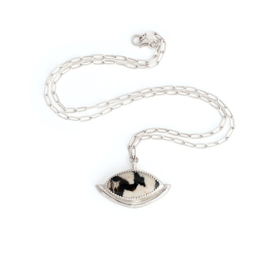 Sterling Silver gemstone Pendant on short paperclip style chain. The pendant features a marquise-cut peanut Wood Cabochon with a striking zigzag pattern in black & white, a serrated sterling silver bezel, and a bamboo style halo mount, cupping the stone.