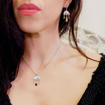 sterling silver half moon pendant, set with mother of pearl, engraved with squirrel illustration, and gemstone drops, on silver twisted oval link chain. Photographed on model