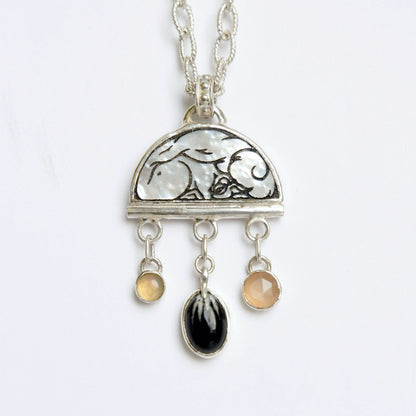 sterling silver half moon pendant, set with mother of pearl, engraved with squirrel illustration, and gemstone drops, on silver twisted oval link chain