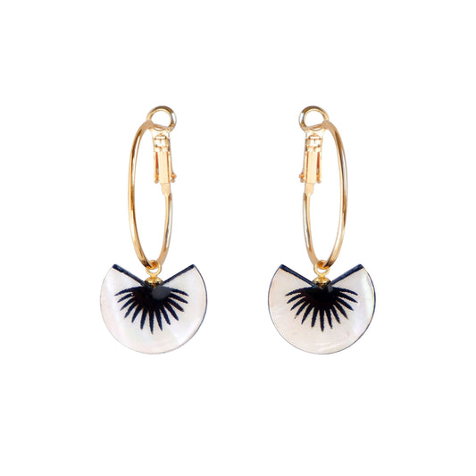 graphic black & mother of pearl spiky palm leaf design pendants on gold hoop earrings