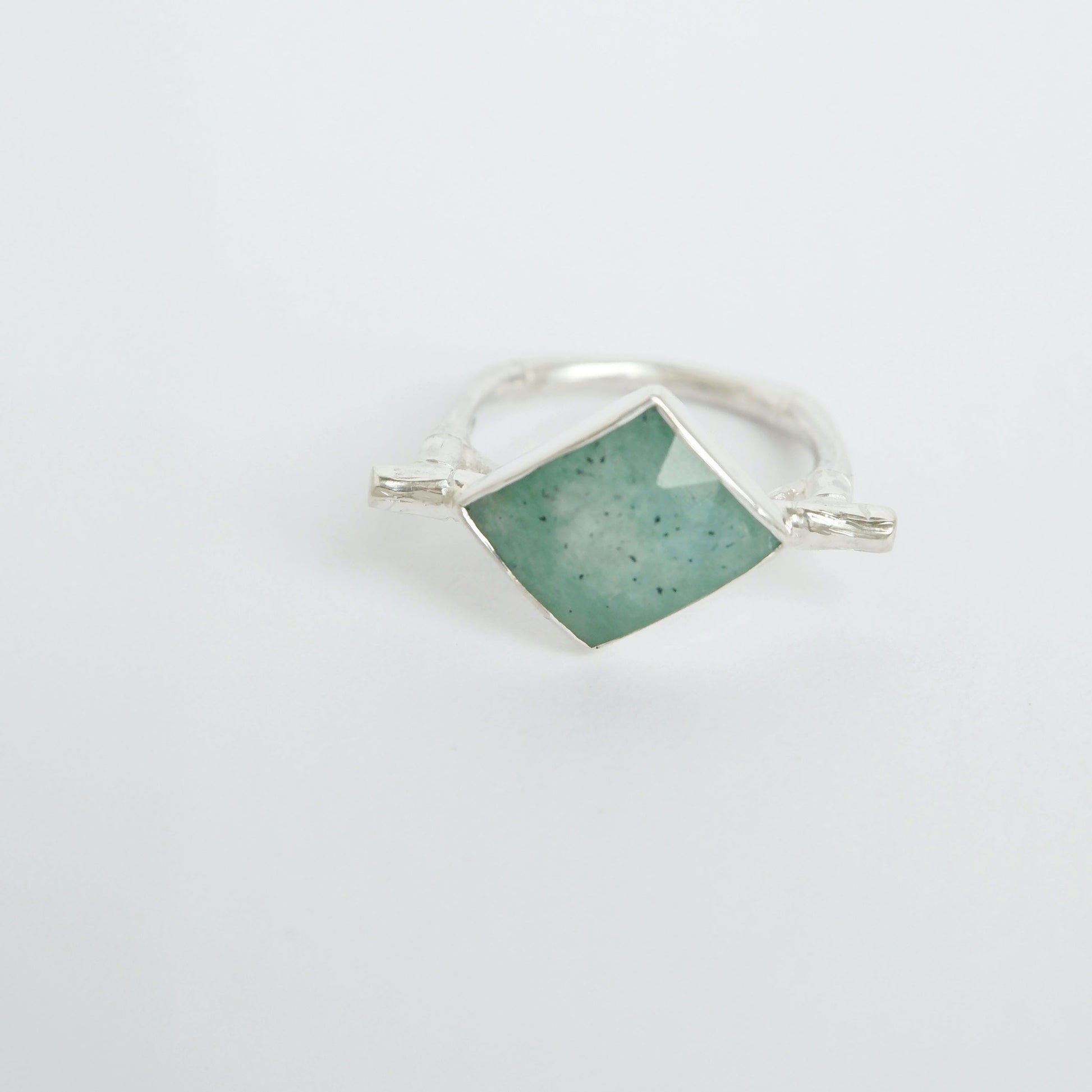 Sterling Silver flat top bamboo style ring with a an irregular angular geometric Amazonite gem stone, on a white background