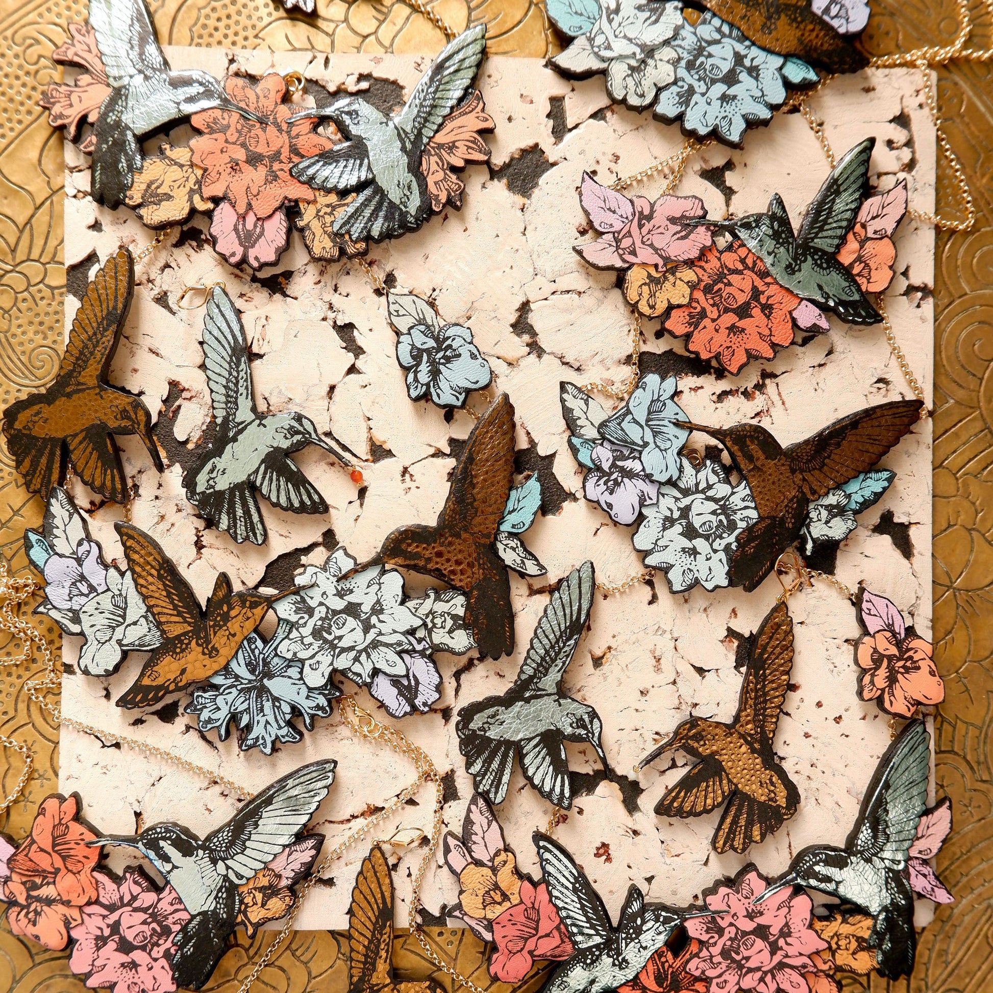 Hummingbird Necklaces in collaged screen-pinted coloured leather, on gold plated chain. 