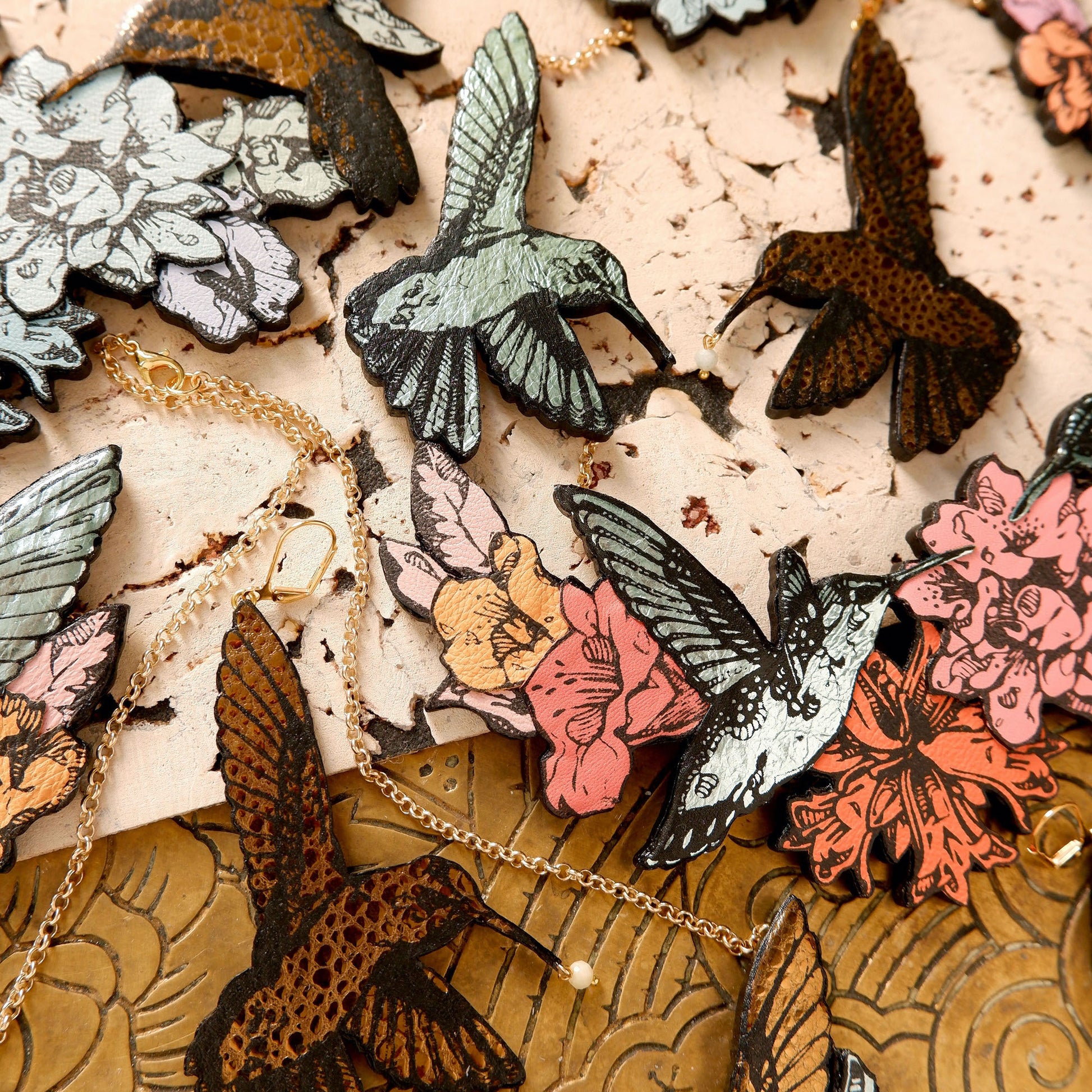 Hummingbird Necklaces in collaged screen-pinted coloured leather, on gold plated chain. 