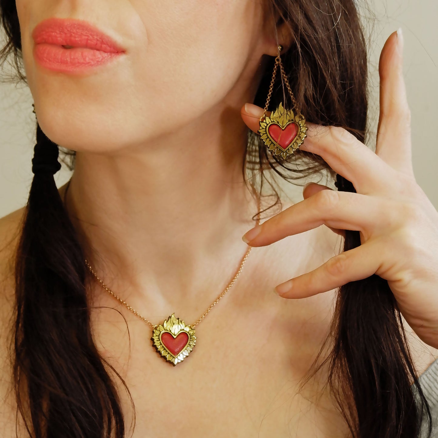 Flaming Heart Pendant, in Gold Foiled Leather, with a Lipstick Red padded leather centre, on Golden Belcher Chain.
On model, with matching Flaming Heart pendant Earrings