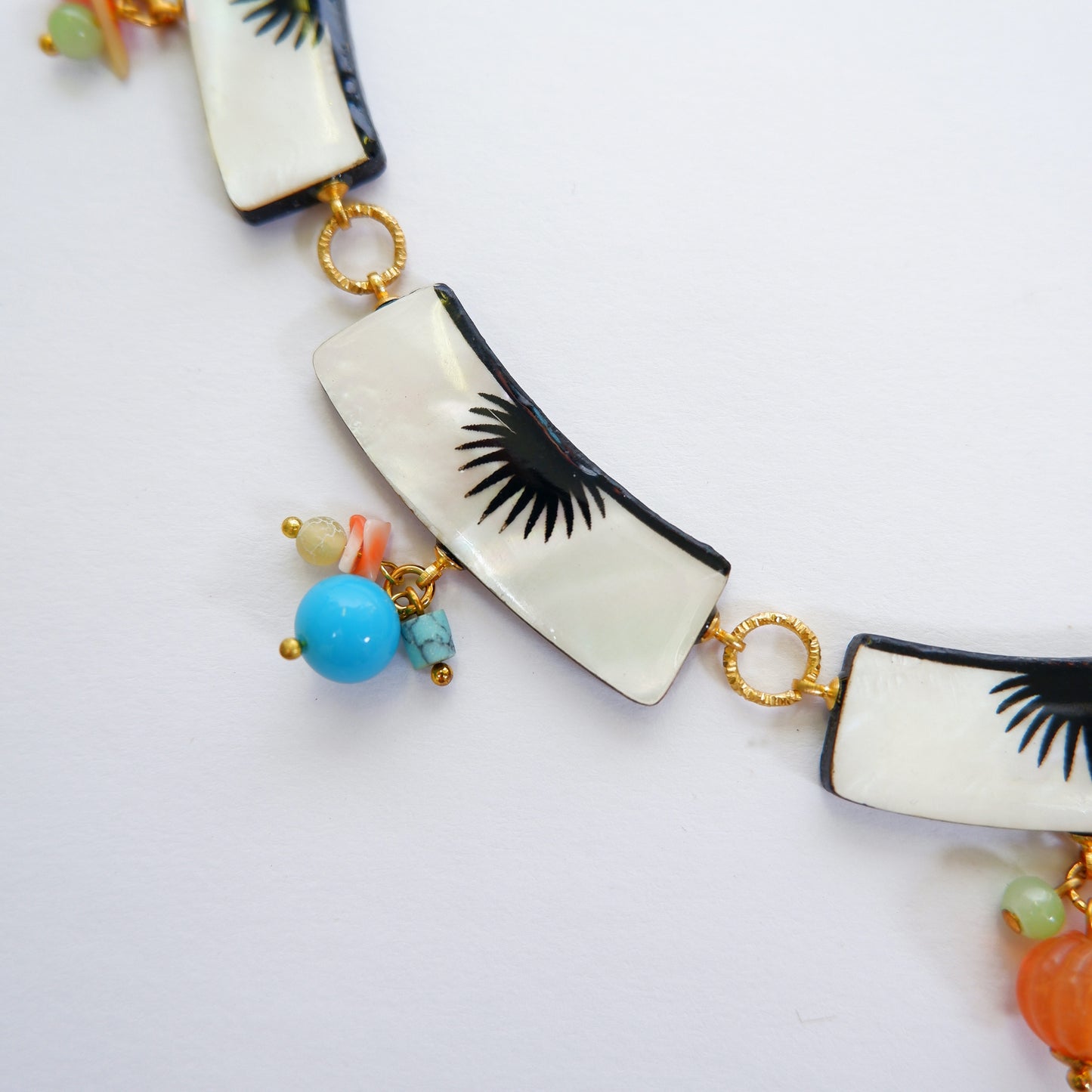 graphic black & white palm design mother of pearl collar necklace, with multi-coloured beads, detail crop