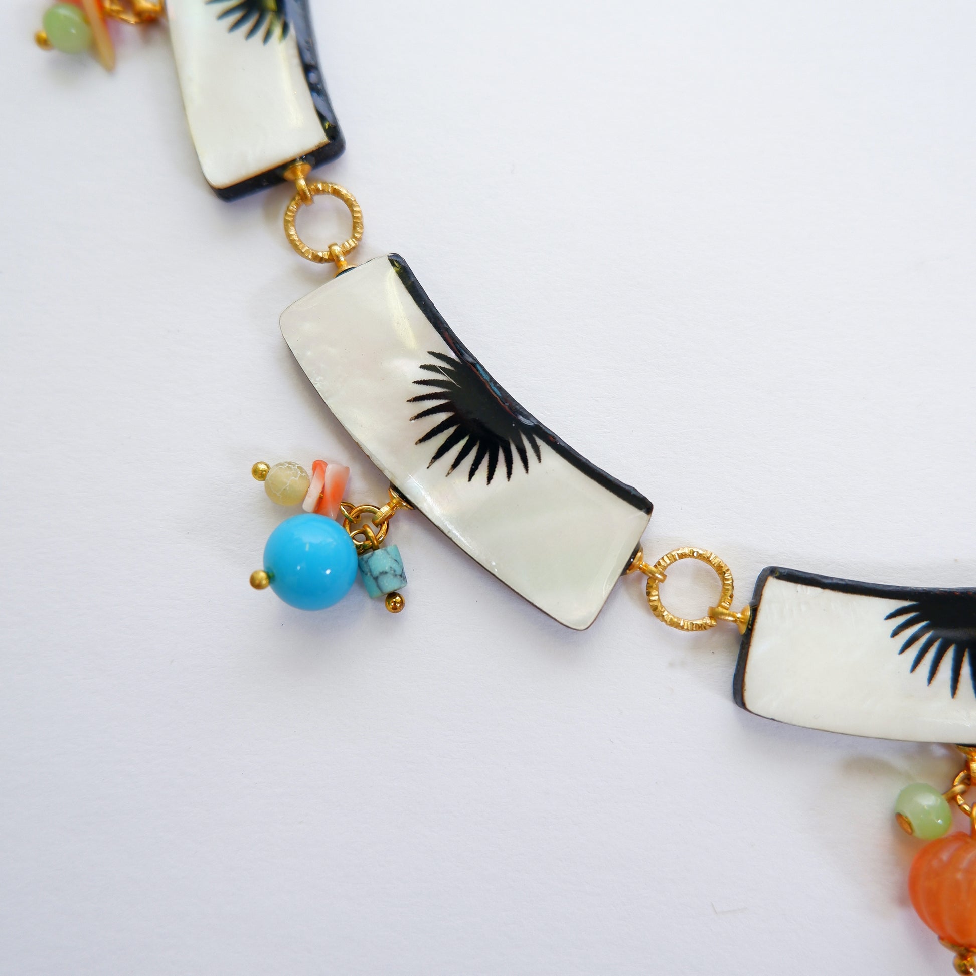 graphic black & white palm design mother of pearl collar necklace, with multi-coloured beads, detail crop