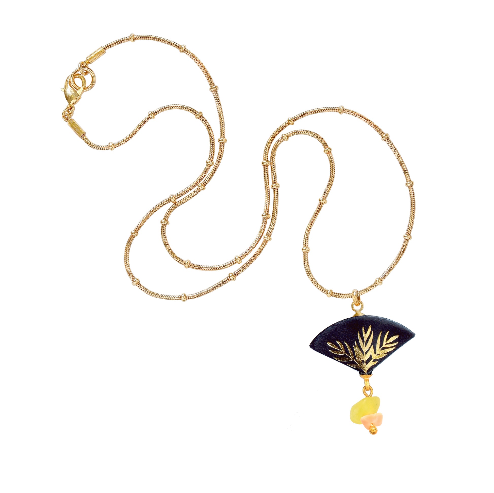 fan shaped leather pendant with gold palm tree print & drop bead, on gold beaded nsake chain