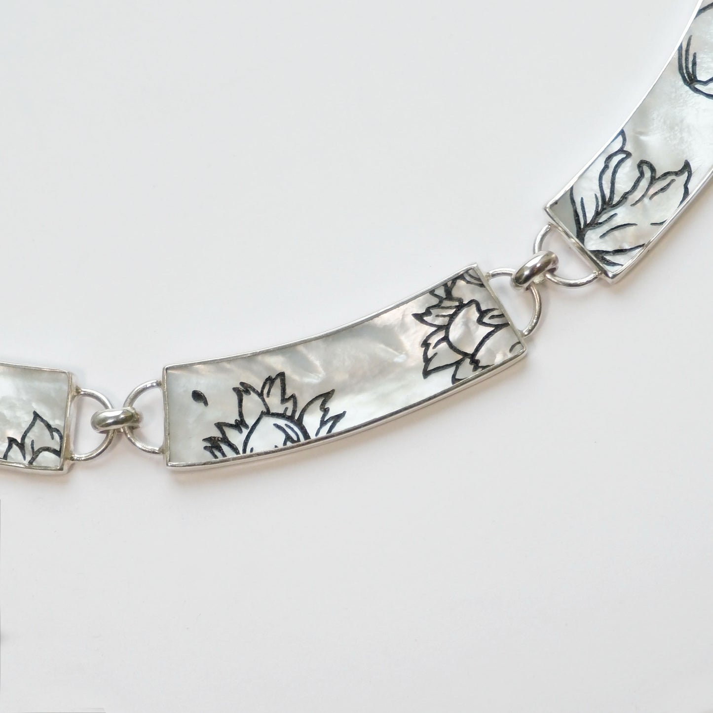 close up view -  panelled mother of pearl collar necklace, with botanical pattern, in sterling silver