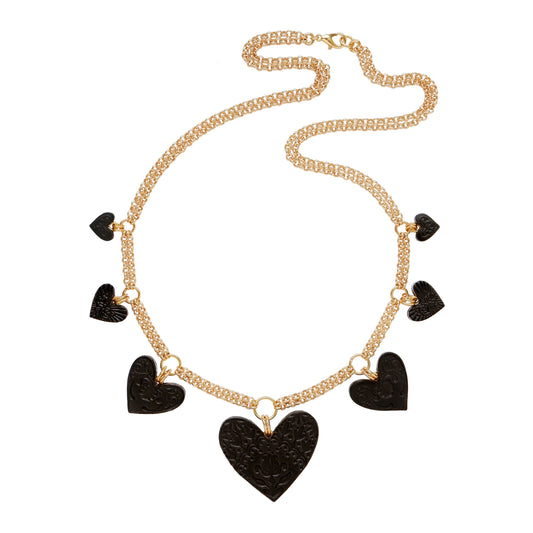 Large charm necklace, featuring 4 sizes of smooth Black Leather Hearts; each embossed with a different folk-art inspired floral design, on double gold-plated belcher chain.