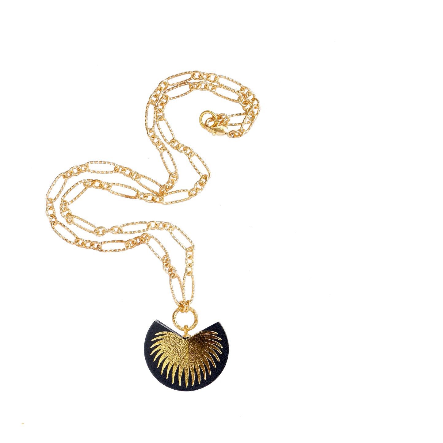 leather medallion pendant with gold palm tree print, on gold chain.