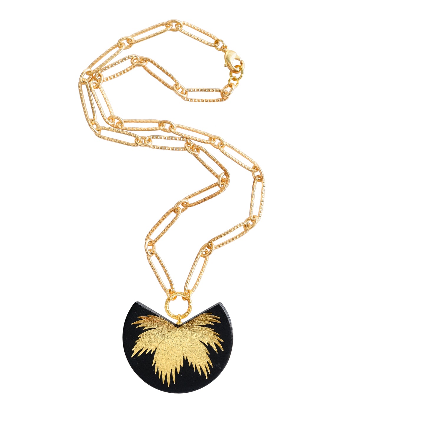 leather medallion pendant with gold palm tree print, on gold chain.