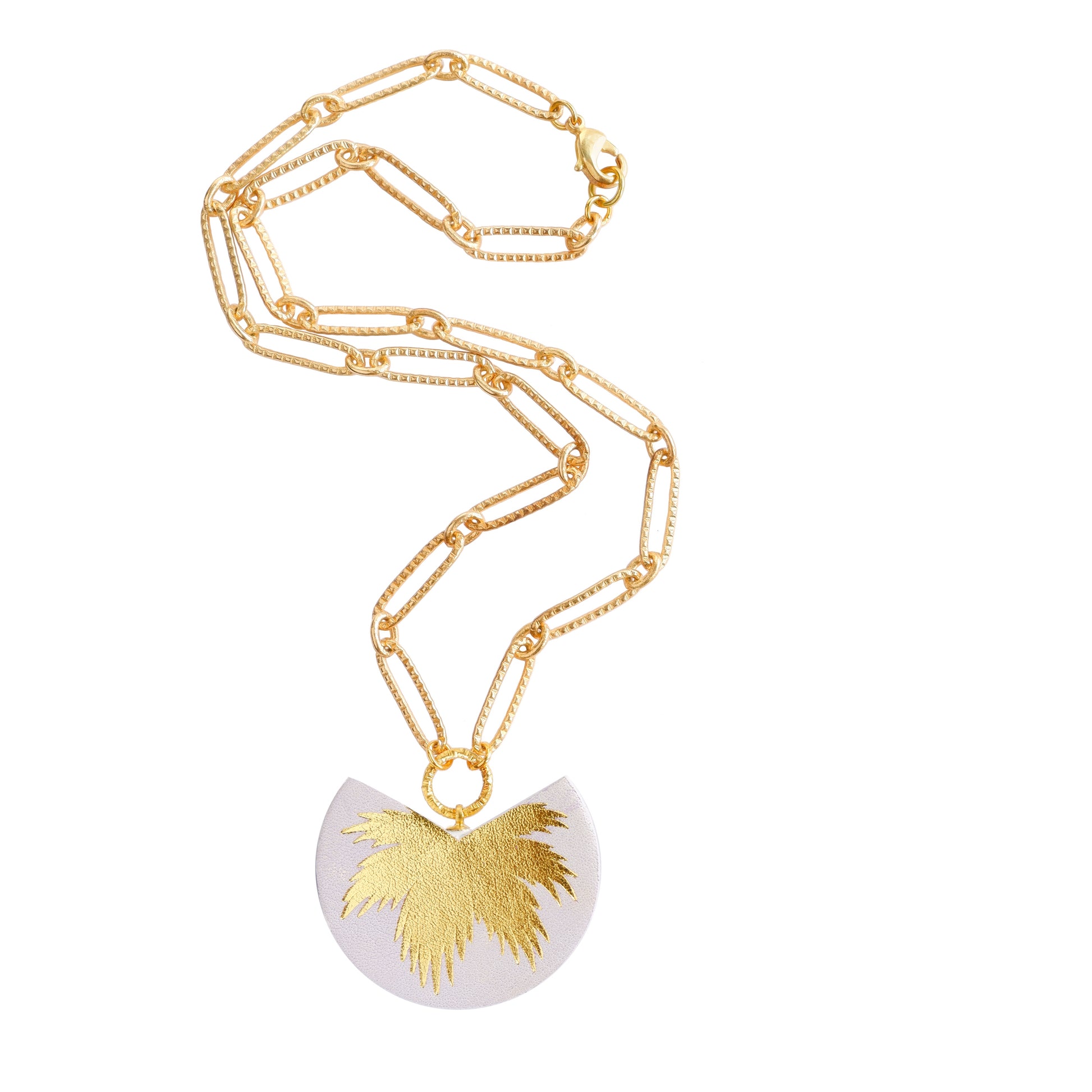 leather medallion pendant with gold palm tree print, on gold chain.