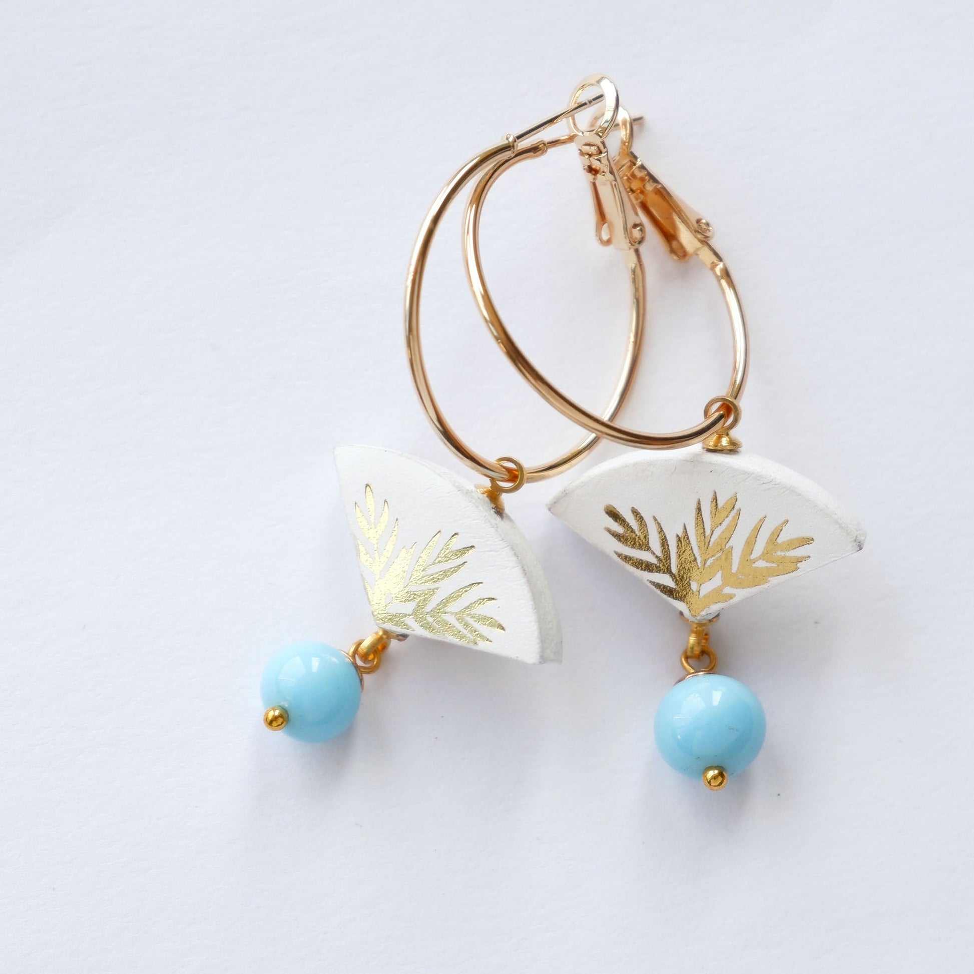 white & gold palm print leather gold  hoop earrings with light blue bead