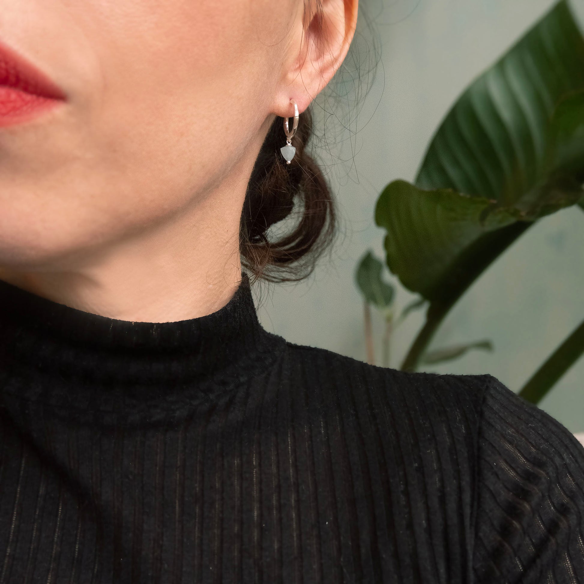 small gold bamboo hoops, with faceted trillion pyramid Aquamarine bead charm, on person