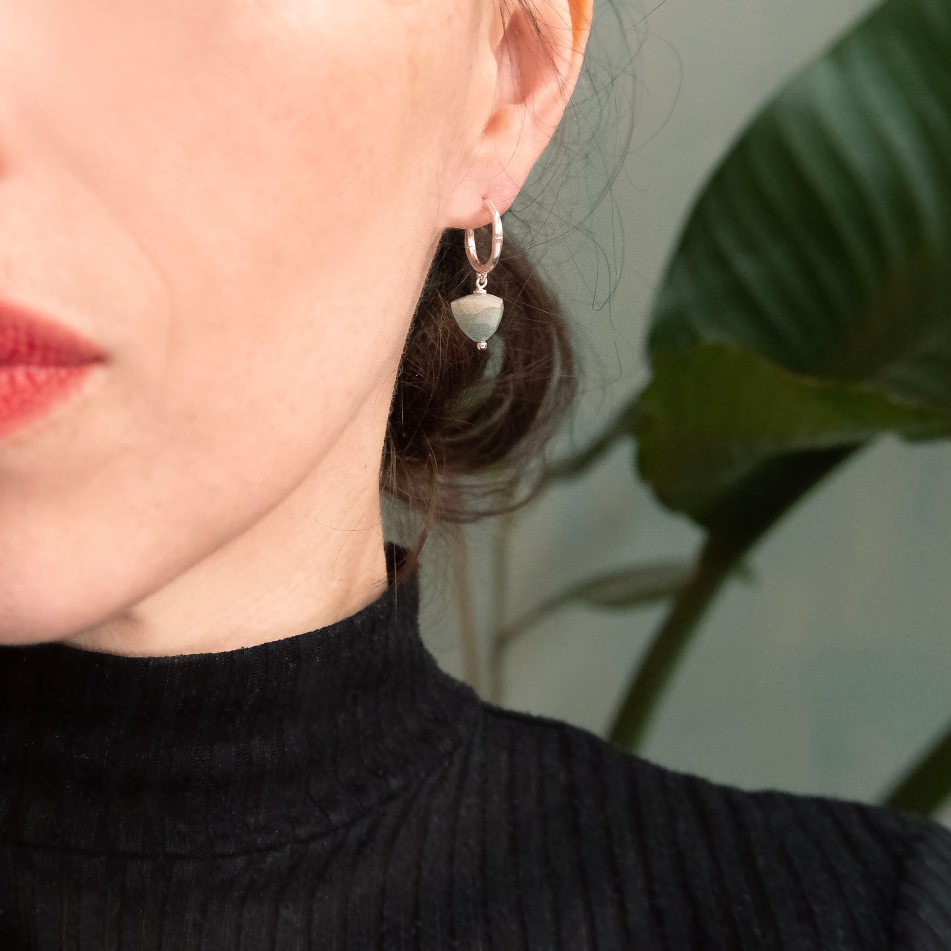 small gold bamboo hoops, with faceted trillion pyramid Aquamarine bead charm, on person