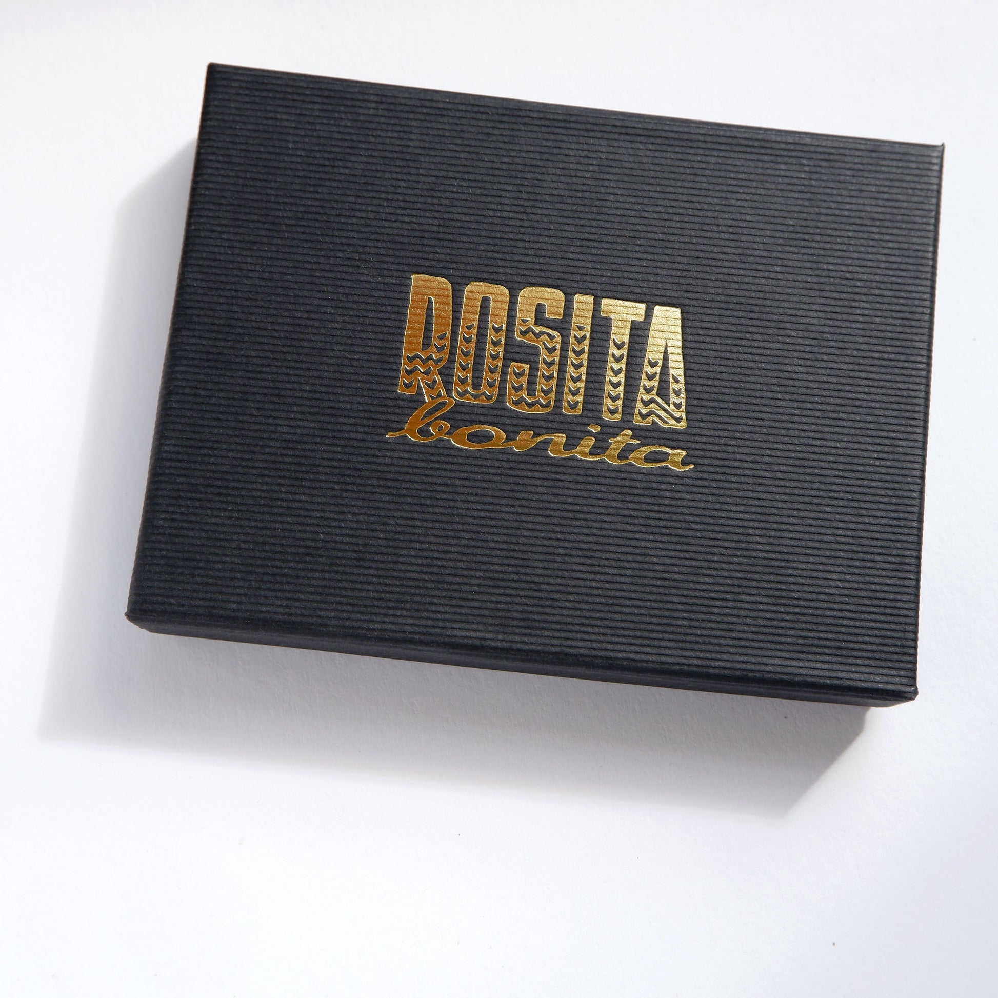 black ift box with rosita bonita logo in gold