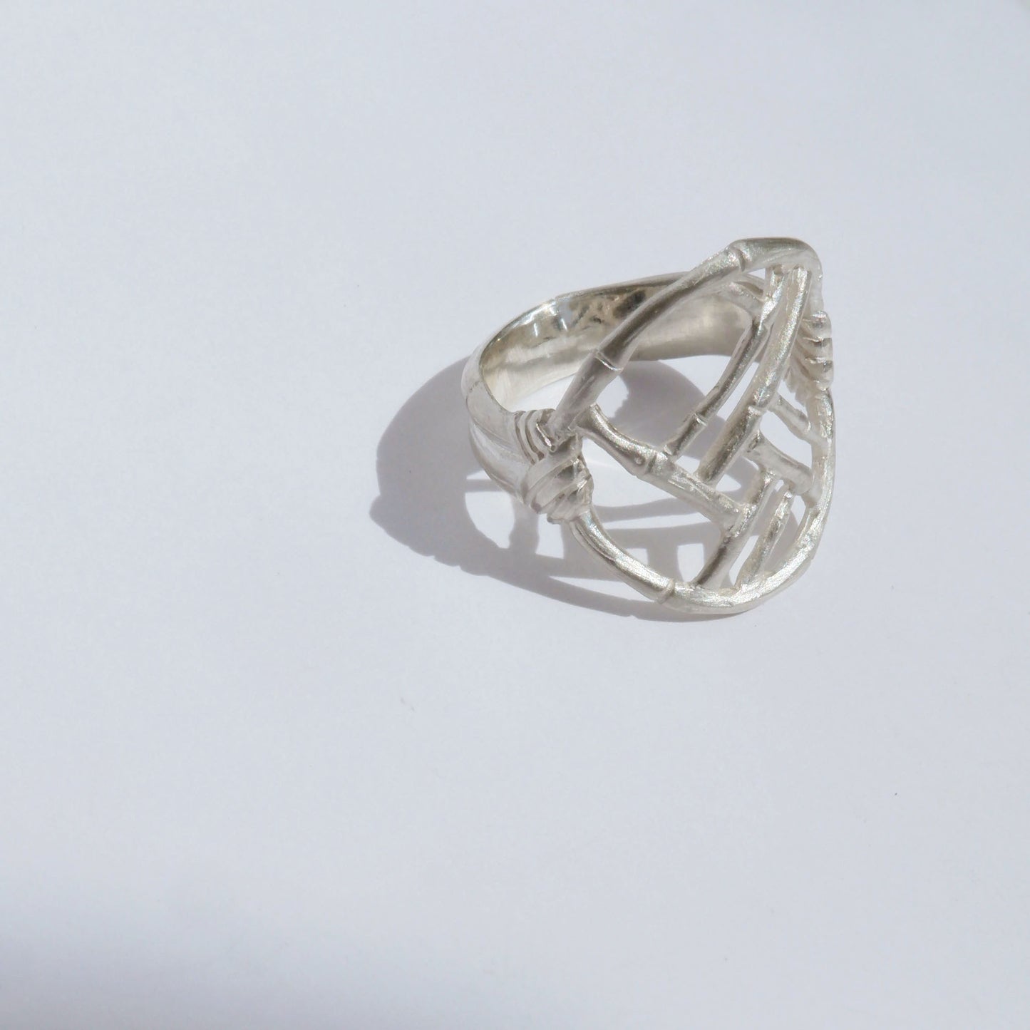 Sterling Silver ring with geometric open-work Bamboo Circle screen design, on a white background