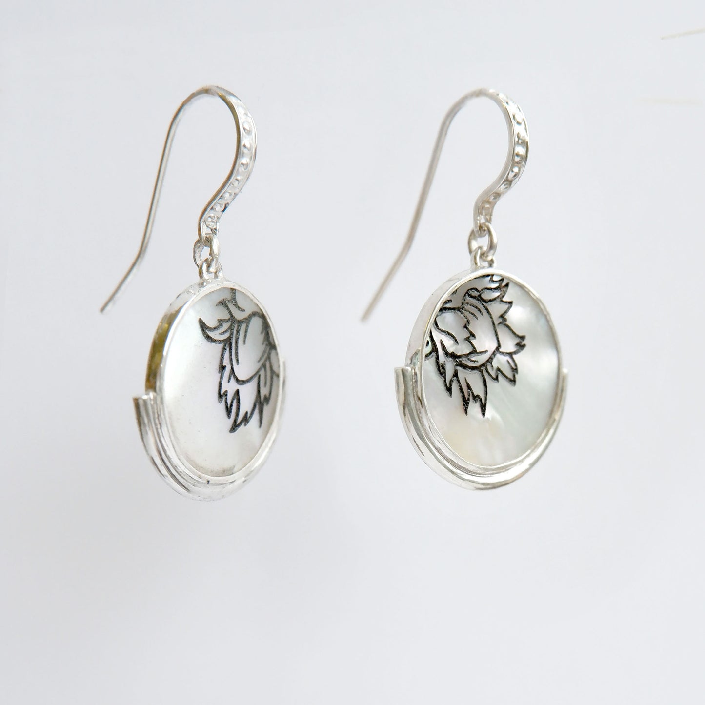 engraved mother of pearl full moon medallion earrings in sterling silver side views
