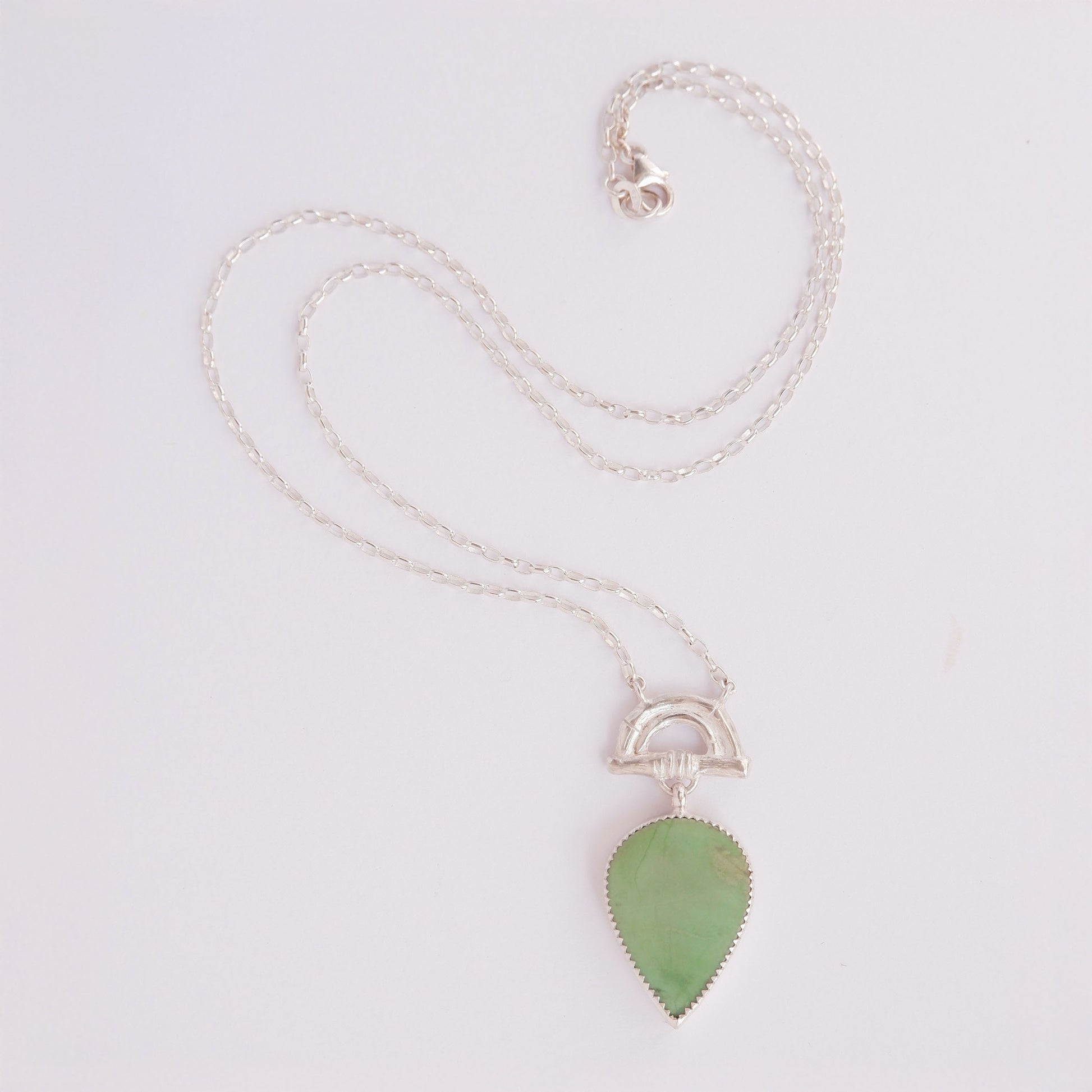 Pendant with long Pear-shaped fGreen Turquoise Gemstone hanging from silver Bamboo Arch, on fine silver chain.