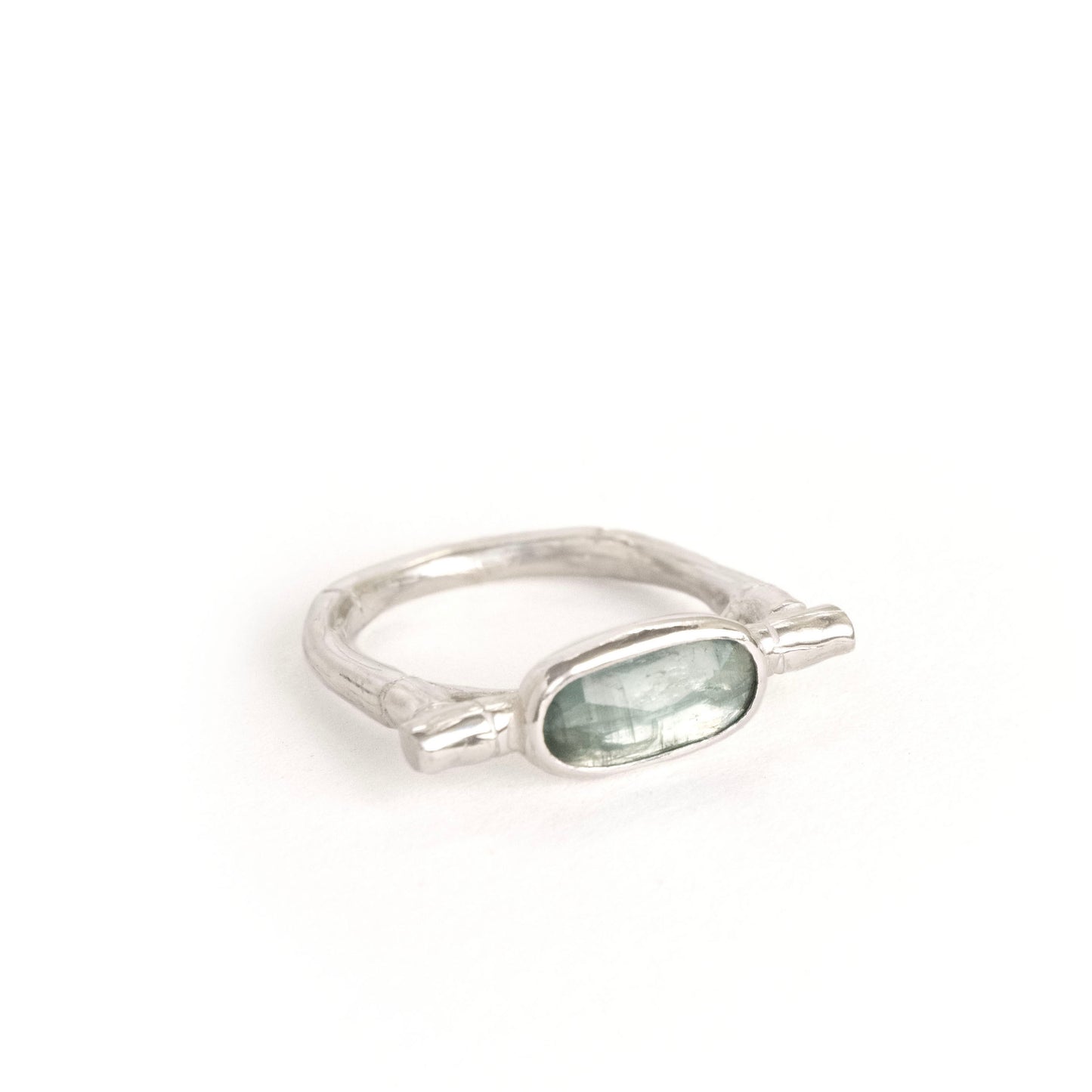 sterling silver organic bamboo cane ring, set with pale mint green kyanite cabochon, white background