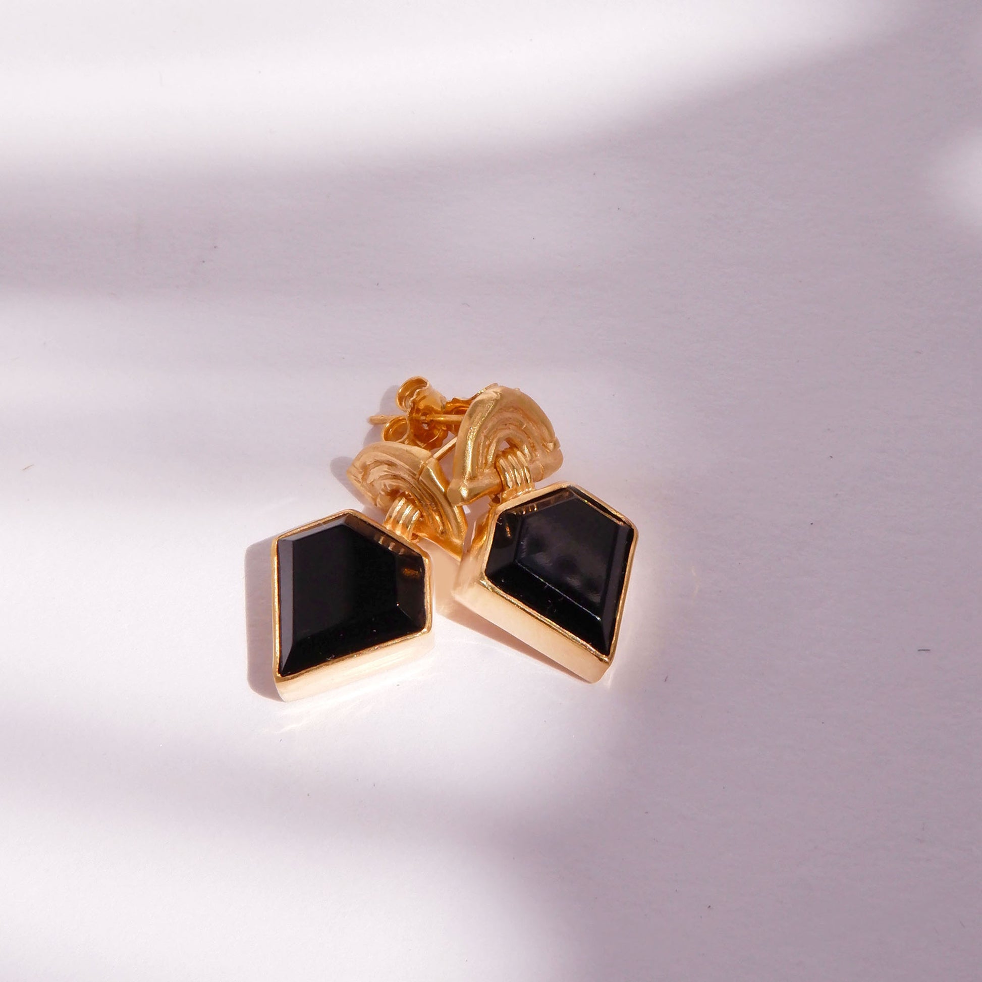 small stud earrings in gold vermeil, featuring triple arches of bamboo, hung with diamond shaped Black Onyx gemstones