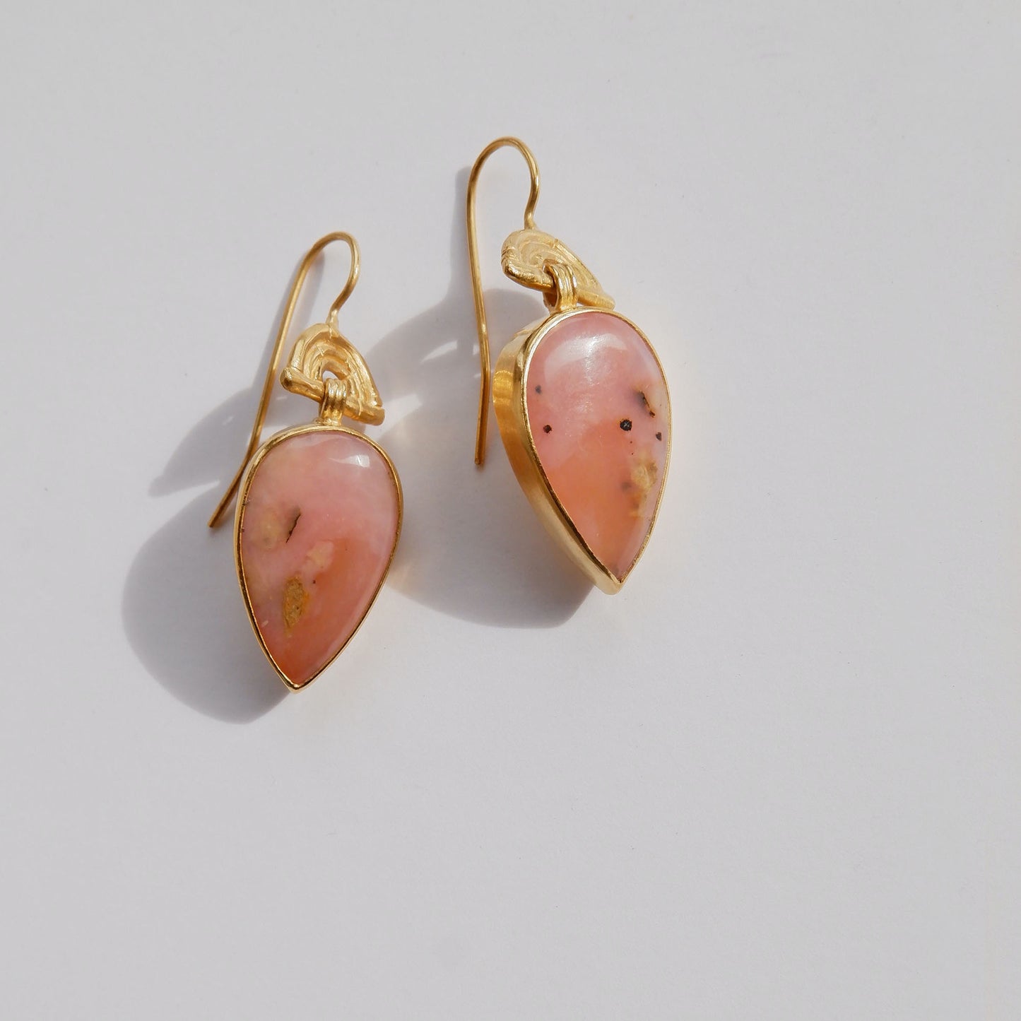 drop earrings in gold vermeil, featuring triple arches of bamboo on hooks, hung with pear/teardrop shaped pink opal gemstone pendants