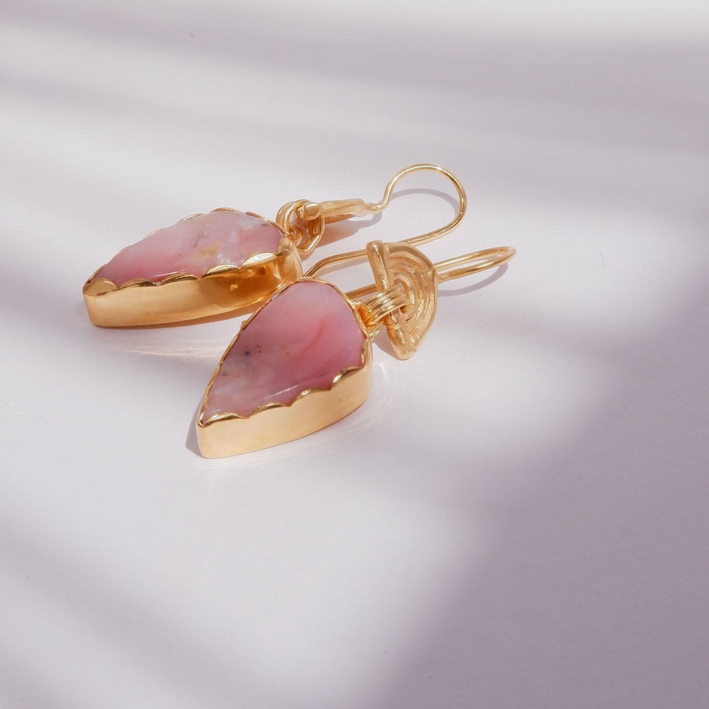 drop earrings in gold vermeil, featuring triple arches of bamboo on hooks, hung with pear/teardrop shaped pink opal gemstone pendants