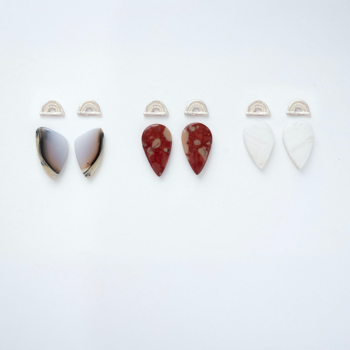 three pairs of sterling silver triple bamboo arches earring tops, with long pointed pear/teardrop shaped  gemstone cabochons in dendrite opal, marbled blood red Mookaite Jasper & White Scolecite