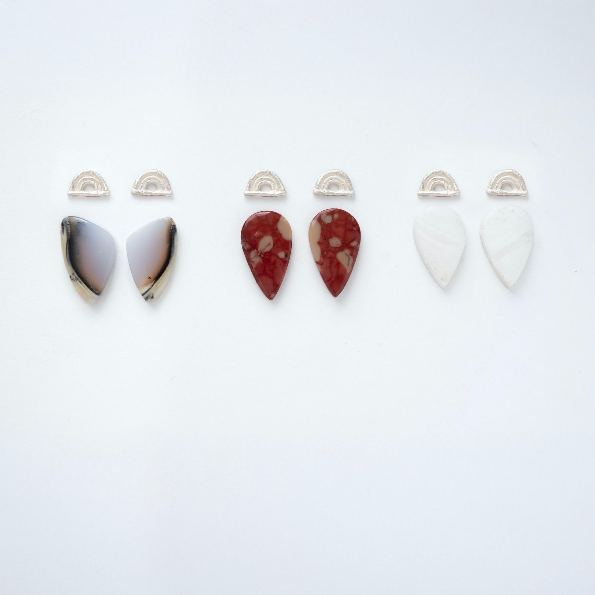 three pairs of sterling silver triple bamboo arches earring tops, with long pointed pear/teardrop shaped  gemstone cabochons in dendrite opal, marbled blood red Mookaite Jasper & White Scolecite