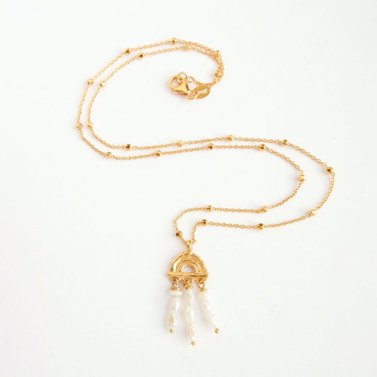 small pendant necklace in Gold Vermeil, featuring a triple arch of bamboo, adorned with short strings of freshwater pearls, on a faceted beaded satellite chain.