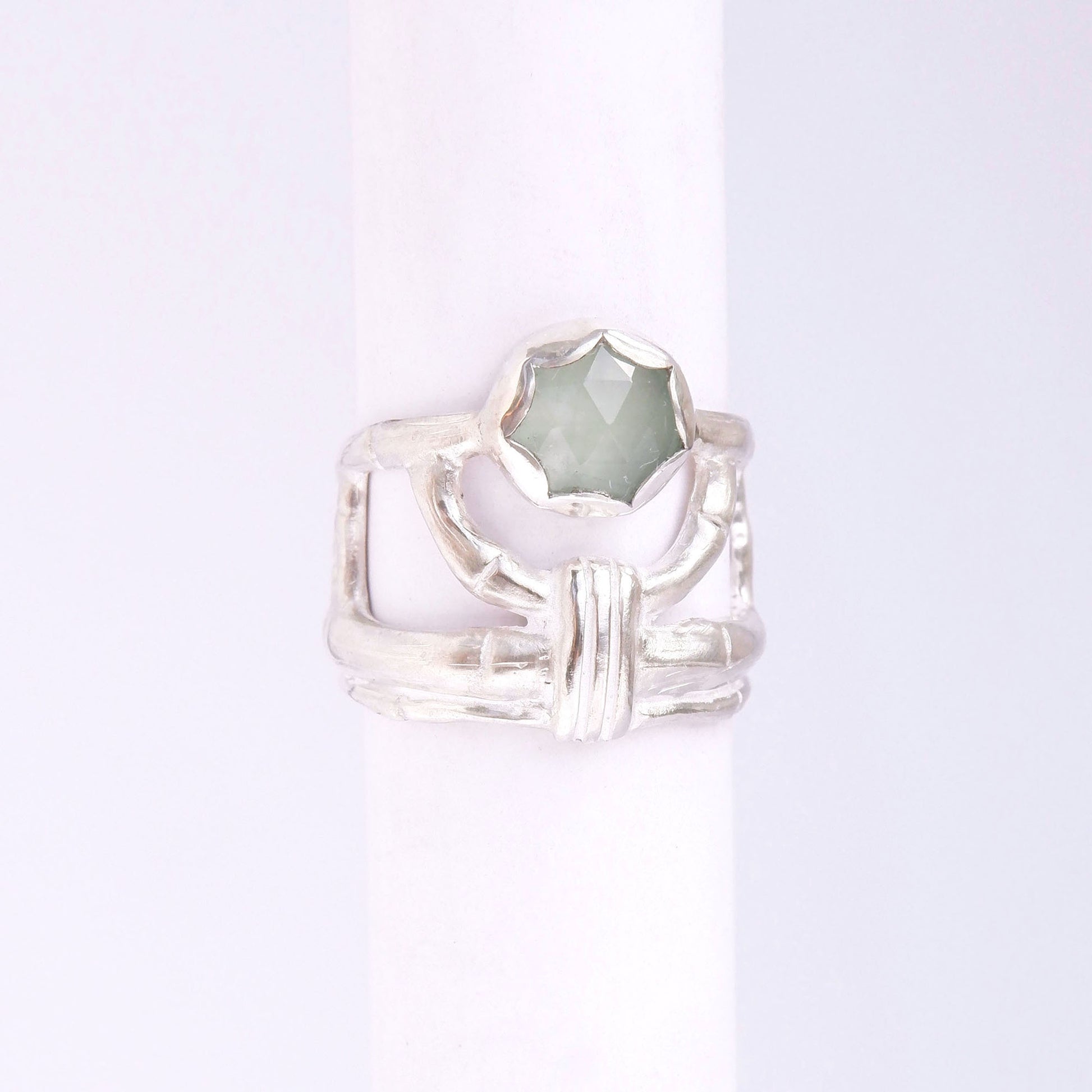 structural open-work ring in a bamboo style, featuring round blue/green cabochon aquamarine gemstone in a scalloped setting. Sterling Silver