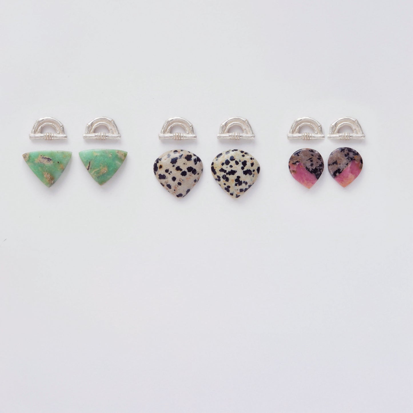 Three pairs of Sterling Silver bamboo sunrise arch design earring tops, with pointed gemstone cabochons in marbled green Chrysoprase, speckled Dalmatian Jasper and Pink, grey & black Rhodonite.