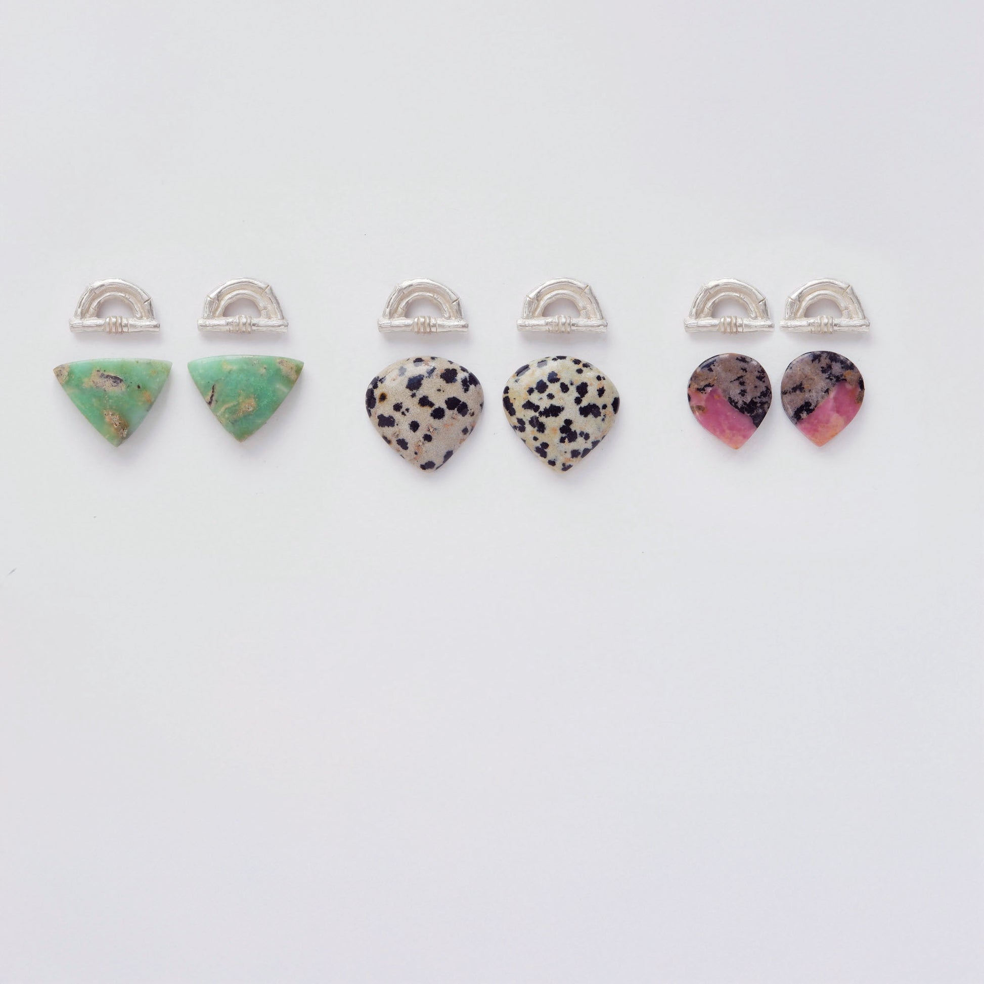 Three pairs of Sterling Silver bamboo sunrise arch design earring tops, with pointed gemstone cabochons in marbled green Chrysoprase, speckled Dalmatian Jasper and Pink, grey & black Rhodonite.
