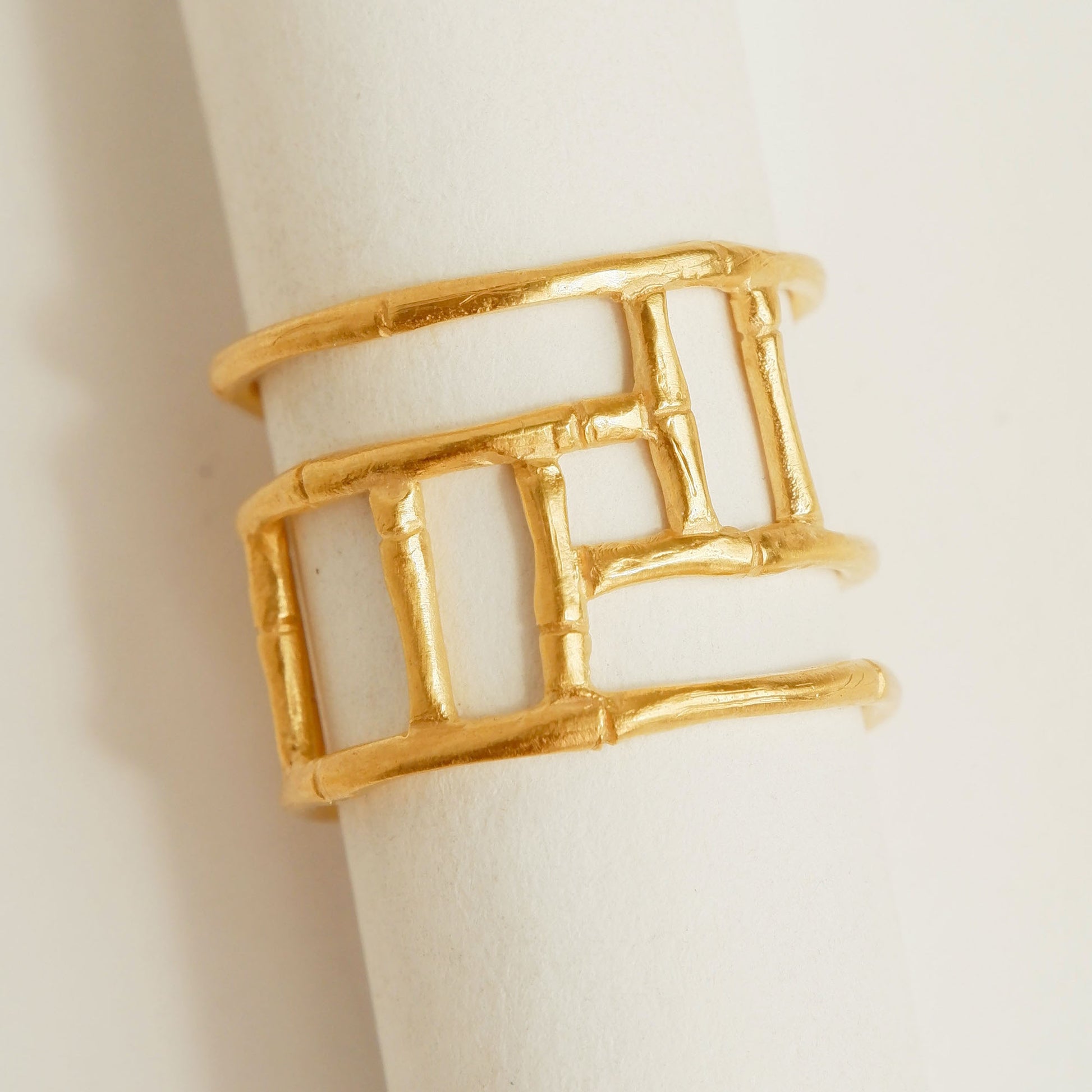 Wide Gold ring with geometric open-work Bamboo screen design, on a white background