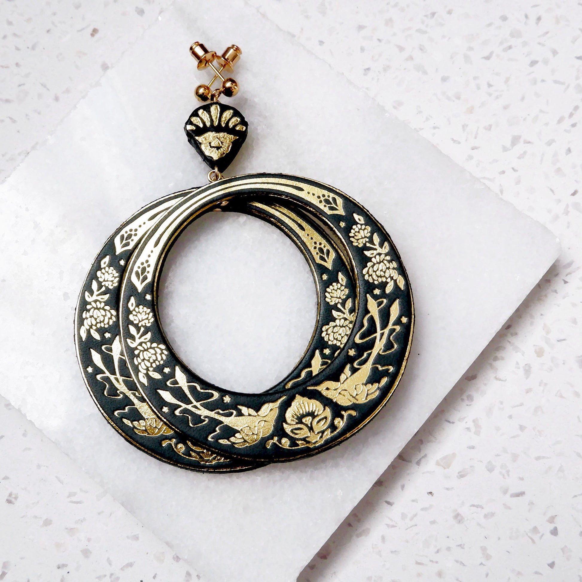 large hoops earring printed with birds & flowers in gold on  black leather