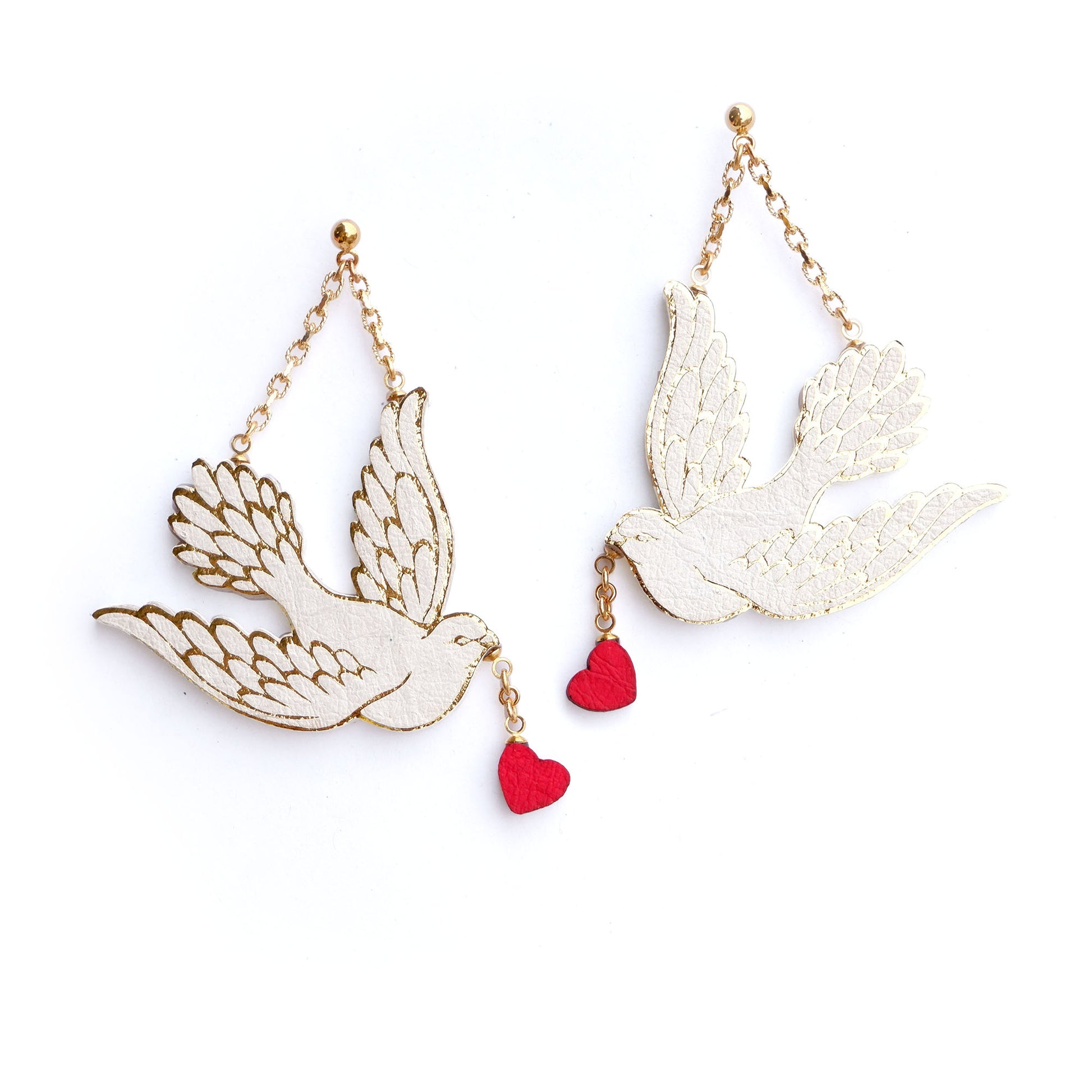 white & gold dove earrings, in a vegan plant based wood pulp & bamboo construction. The doves carry little red hearts in their beaks.
